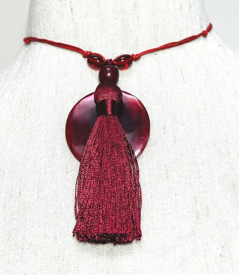 Dark red disc, beads and tassel on red string drop necklace (N-409)