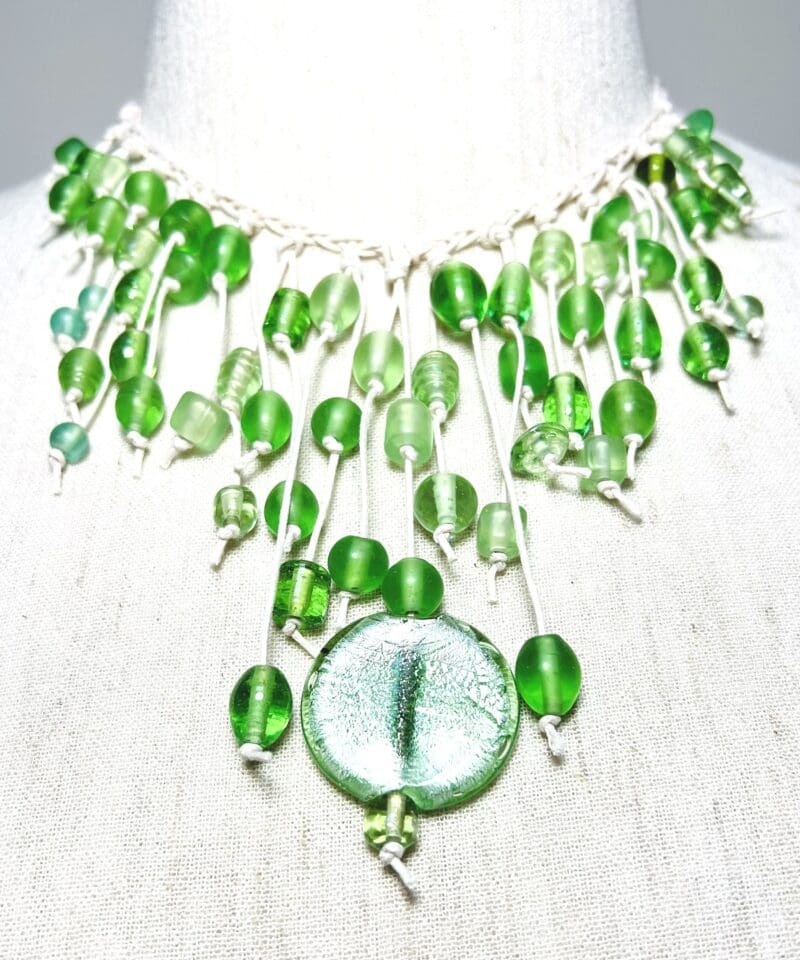 Variety of green glass beads and disc dangle necklace on cream string (N-413)