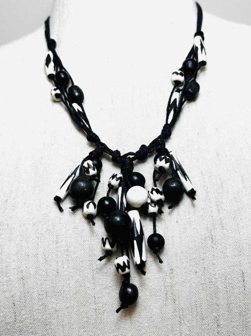 Cream/black pattern bone beads fancy dangle necklace on black string (N-421)