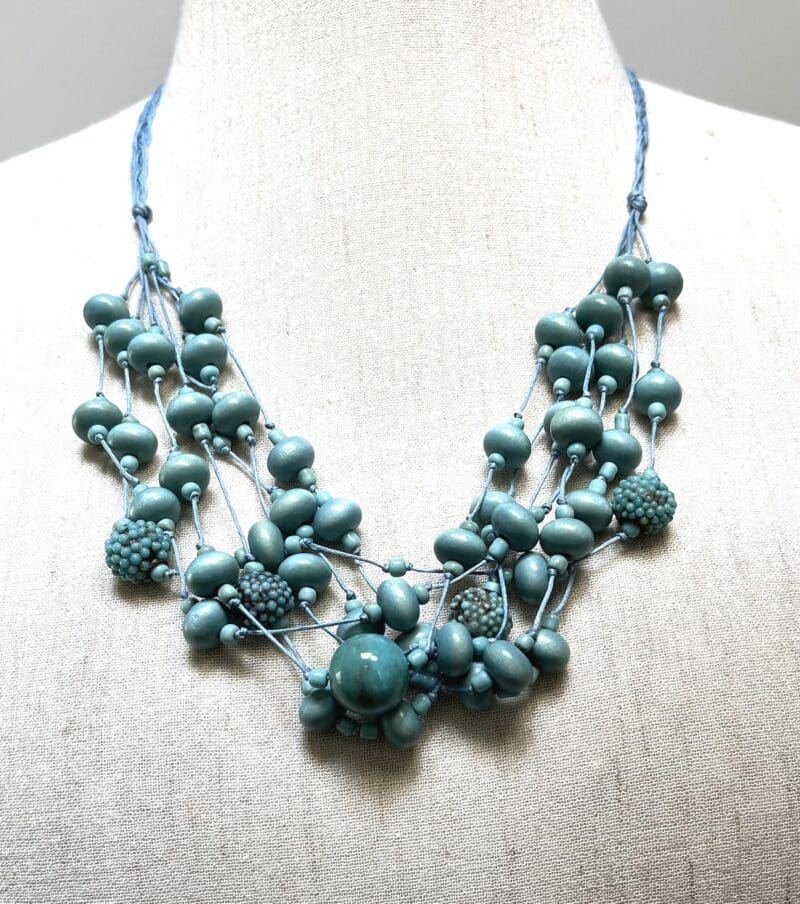 Variety of light turquoise wood and other beads 7-strand necklace on light blue string (N-443)