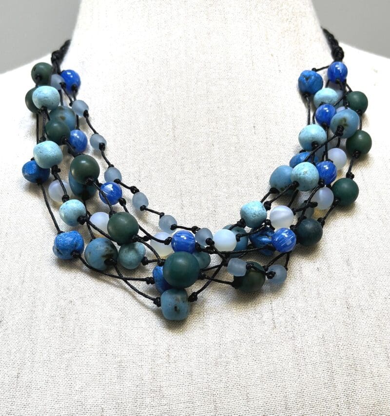 A variety of blue, turquoise and green beads 7-strand necklace on black string (N-445