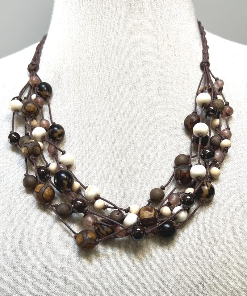 A variety of cream and fancy brown beads 7-strand necklace on brown string (N-446)